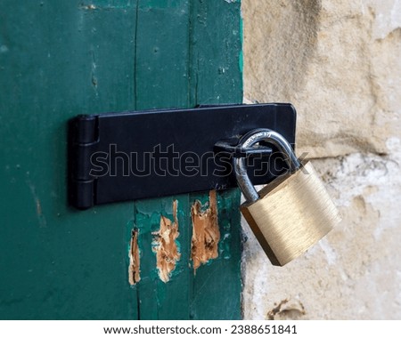 Closed padlock on hasp and staple Royalty-Free Stock Photo #2388651841