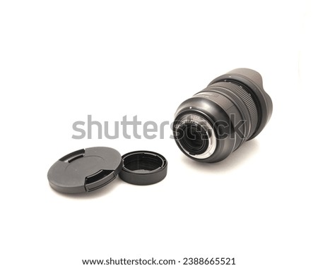 Cap, hood and advanced aspherical landscape lens made in Japan for DSLR full frame camera photography isolated on white background with clipping path copy space. Digital photo equipment