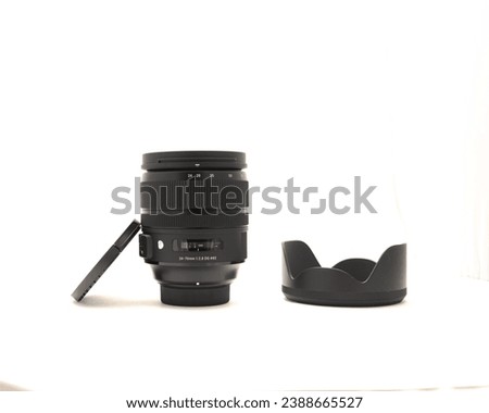Cap, hood and advanced aspherical landscape lens made in Japan for DSLR full frame camera photography isolated on white background with clipping path copy space. Digital photo equipment