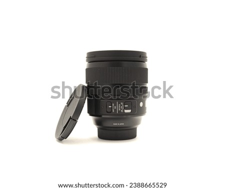 Black advanced aspherical landscape lens with cap made in Japan for DSLR full frame camera photography isolated on white background with clipping path copy space. Digital photo equipment accessory