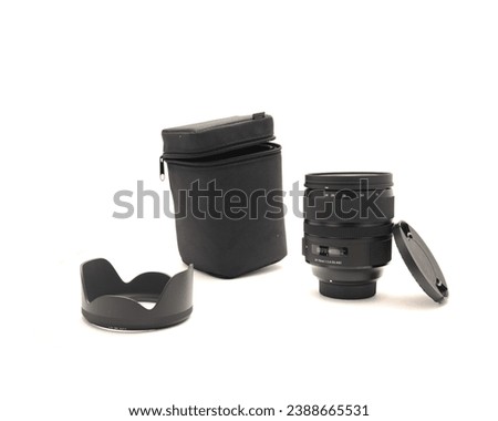Soft padded case, Box, cap, hood and brand-new advanced aspherical landscape lens with cap made in Japan for DSLR full frame camera photography isolated on white background. Clipping path copy space
