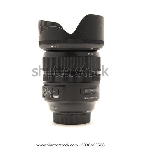 Camera lens with hood to reduce flares made in Japan for DSLR full frame camera photography isolated on white background with clipping path copy space. Digital photo equipment accessory