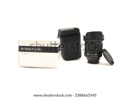 Box, cap, hood and brand-new advanced aspherical landscape lens with cap made in Japan for DSLR full frame camera photography isolated on white background, clipping path copy space. Digital photo
