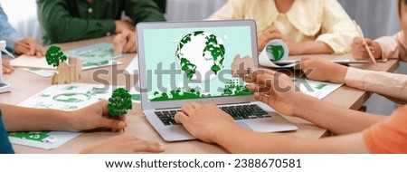 Green city logo displayed on a laptop at a green business meeting. Team presenting green design to customer. ESG environment social governance and Eco conservative concept. Closeup. Delineation.