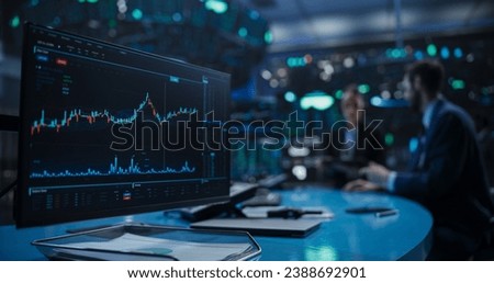 Close Up on a Computer Screen with Real-Time Stock Market Analytics, Graphs and Reports. Stock Exchange Software Template. Brokers Discussing Financial and Business Opportunities in the Background