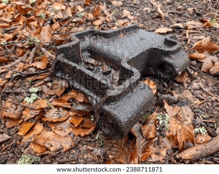 Among the fallen brown leaves lies a piece of metal track - a relic of an armored self-propelled vehicle from World War II. This juxtaposition evokes a poignant reminder of history Royalty-Free Stock Photo #2388711871