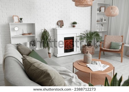 Interior of living room with modern fireplace and sofa