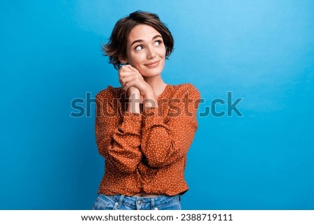 Photo of adorable attractive lady hold arms near face admiring look side dreamer wear casual outfit isolated blue color background Royalty-Free Stock Photo #2388719111
