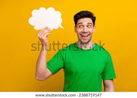 Photo of young excited funny positive guy wear green t shirt holding bubble cloud crown phrase in film isolated on yellow color background Royalty-Free Stock Photo #2388719147