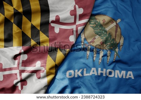 big waving colorful national flag of oklahoma state and flag of maryland state . macro