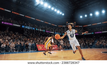 Athletic Multiethnic Player Running To Score Slam Dunk Goal in Front of a Crowded Arena. College Basketball Tournament Cinematic Shot with Two Young Teams Playing a Championship Match