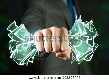 Close up of businessman grasping dollar banknotes in fist