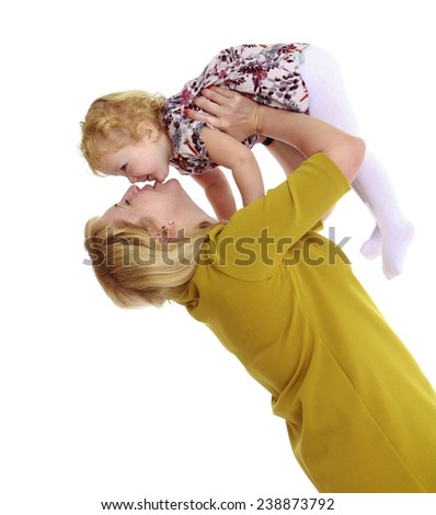Gentle mother kisses his beloved daughter. Isolated on white background studio photo.