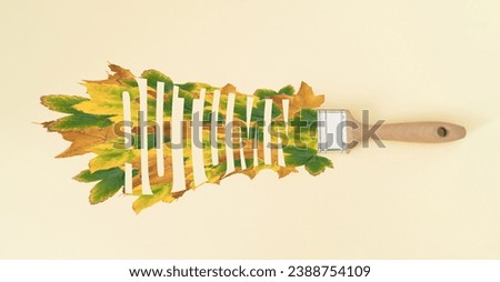 Creative autumn layout made of brush and colorful fallen leaves on pastel background. Season concept. Minimal autumn or fall idea. Autumn aesthetic background. Flat lay, top of view.