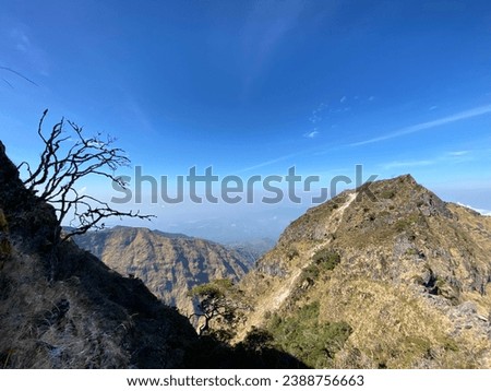 expanse of mountains and clear skies