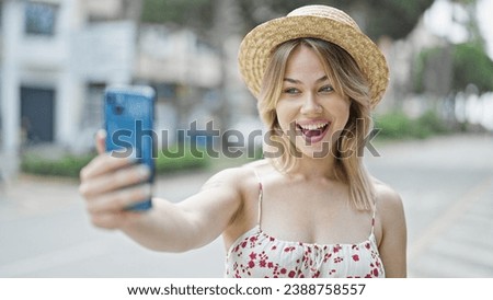 Young blonde woman tourist smiling confident make selfie by smartphone at street