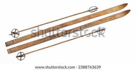 old wooden skis and ski poles isolated on white background