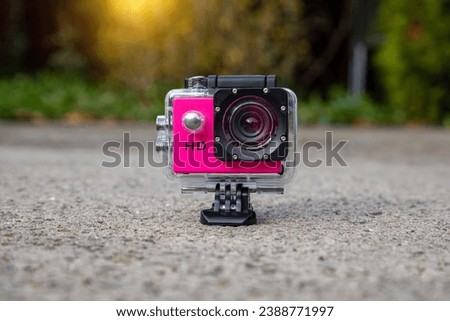 Action camera in a protective box for shooting dynamic videos. Royalty-Free Stock Photo #2388771997