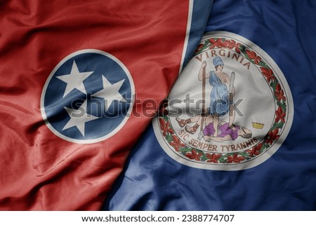 big waving colorful national flag of virginia state and flag of tennessee state . macro