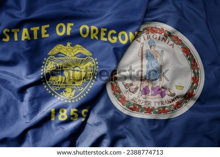 big waving colorful national flag of virginia state and flag of oregon state . macro