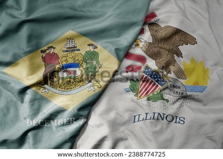 big waving colorful national flag of illinois state and flag of delaware state . macro