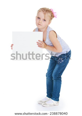 Little girl holds up a piece of cardboard for advertising .Isolated on white background studio photo.