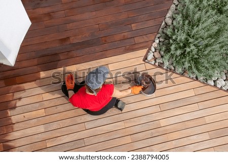 Stain a wood decking boards diy concept, hardwood care Royalty-Free Stock Photo #2388794005