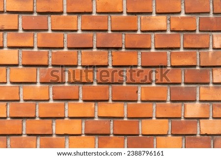 A wall made of regular brown bricks