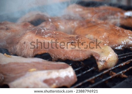 The picture shows the roasted pork sizzling hot and ready to be eaten on the stove.pork roast, on the iron stove, top view, Spicy Grilled Pork Chop,Summer Barbecue, Juicy and Smokey Flame grilled pork