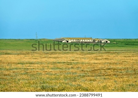 An old abandoned sheepfold shed with sheephouse (sheep farm) in the steppe. Soviet Union sheep industry (sheep-breeding sovkhoz - collective economy). Crimea Royalty-Free Stock Photo #2388799491
