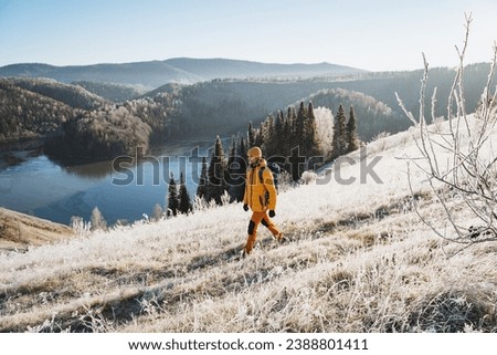 Winter hiking in the mountains, guy hiking in winter forest, trekking alone, beautiful mountain landscape, land of lakes. High quality photo