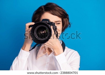 Photo of positive pretty lady arms hold camera taking picture tied on neck scarf isolated on blue color background