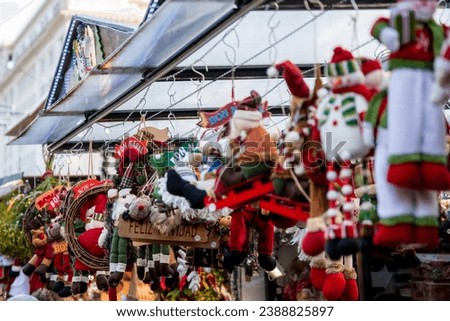 Santa Llucia Market's festive embrace: A vibrant stall brimming with Christmas plush toys, adorned with 'Feliz Navidad' and 'Bon Nadal,' capturing the joy of the season in Barcelona. Royalty-Free Stock Photo #2388825897