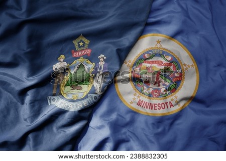 big waving colorful national flag of minnesota state and flag of maine state . macro