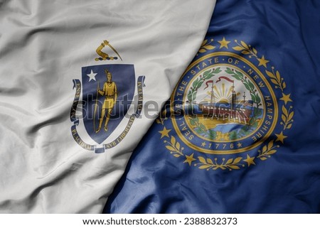 big waving colorful national flag of new hampshire state and flag of massachusetts state. macro