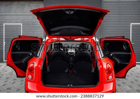Compact, stylish and youthful crossover in bright red color. Modern black car interior.  Details interior.  Royalty-Free Stock Photo #2388837129