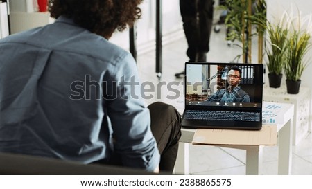 Diverse people meeting on online call, consultant using videoconference chat to present small business vision. Young employee talking to coworker on remote telework videocall. Tripod shot. Royalty-Free Stock Photo #2388865575