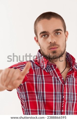 The gesture and stern look of the man clearly communicate a message of disagreement Royalty-Free Stock Photo #2388866595