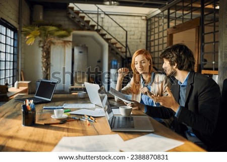 Diverse coworkers Analyzing Document in Office Setting Royalty-Free Stock Photo #2388870831