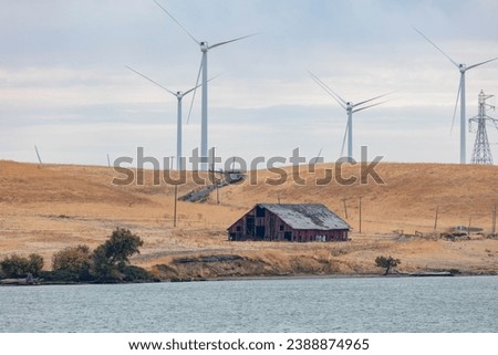 A windmill energy wind farm in Rio Vista, California  Royalty-Free Stock Photo #2388874965