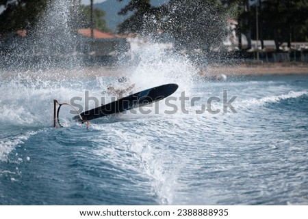 A person falling from a monoski onto the water, providing an authentic depiction of the thrill and dynamics of watersport activities. The unexpected moments making water adventures unforgettable Royalty-Free Stock Photo #2388888935
