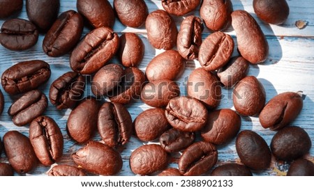 Coffee beans on wooden texture background 