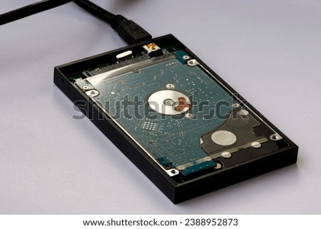 A computer's hard disk hdd data storage drive without shield in white background. Computer PC and laptop or notebook storage hardware. Hard Disk Drive for computer PC and notebook. 