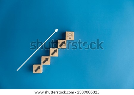 Stair wooden blocks bright light bulb arrows up, ideas, creativity, thoughts, knowledge, education, imagination, new things, research.