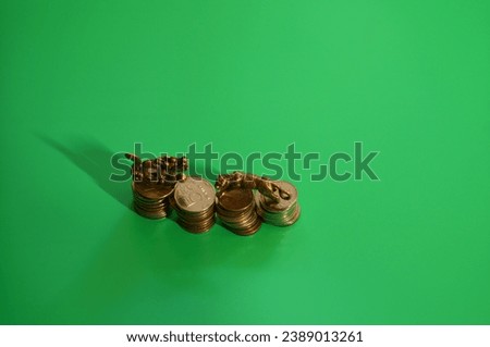 Dragon and tiger figurine with coins on a green background.