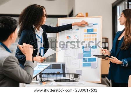 diverse team of professionals engaged in a website graphic design board meeting, sharing opinions on UX and UI design elements. Asian man, African American people, black, afro, caucasian female