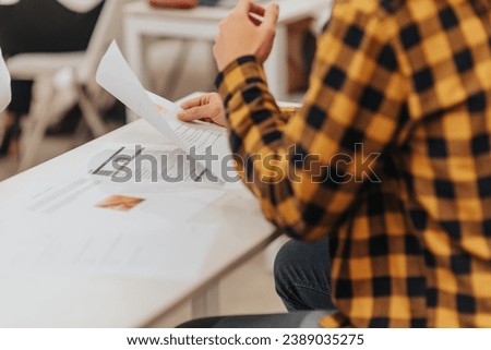 Close up photo of male employee working on financial reports and statistics