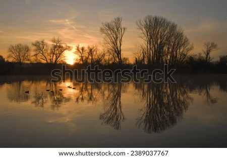 Flood Plain By Sunrise, River Landscape in a Beautiful Sunrise, Tree Are Reflected in a Lake By Golden Hour, A Fairy Tale Scene By Sunrise At A River, The Beauty of a Intact Nature,  Royalty-Free Stock Photo #2389037767