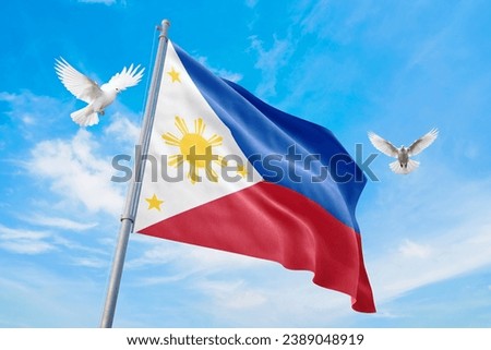 Waving flag of Philippines in beautiful sky and flying pigeons. Philippines flag for independence day. The symbol of the state on wavy fabric.