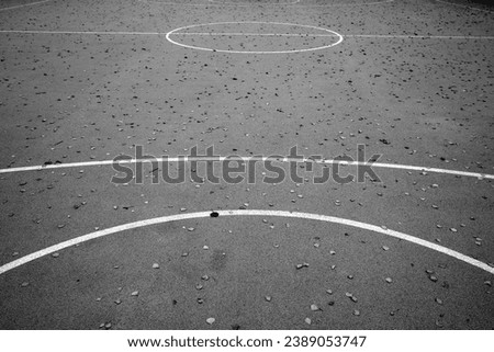 Basketball court in autumn with fallen leaves on it. Seasonal sport background.                   